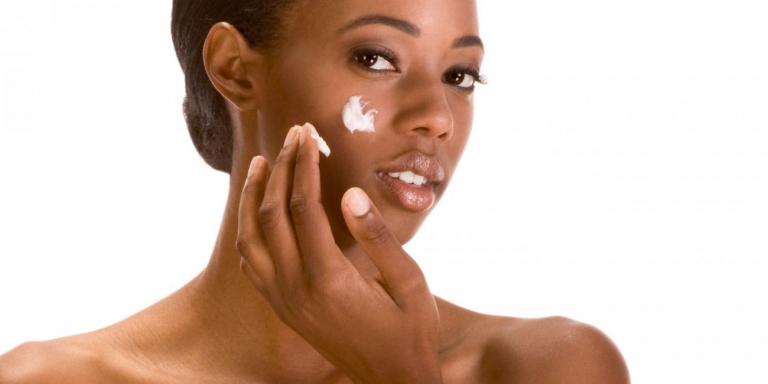 A woman moisturizing her skin naturally.